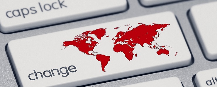 An extreme close-up of a keyboard, focused on the shift key which now says "change" and has a red map of the world.